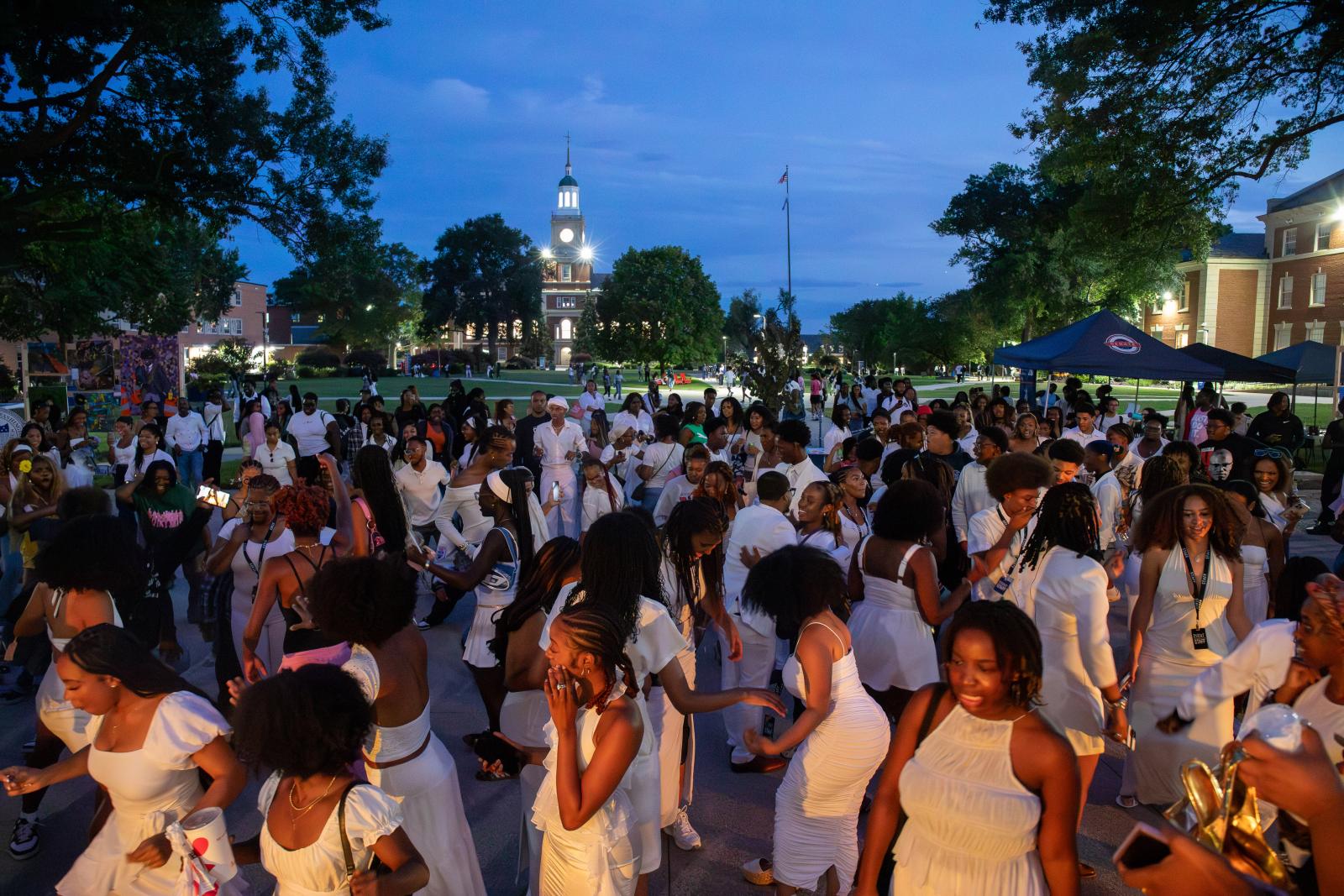 Students gathered on the Yard at night during Boseman Day
