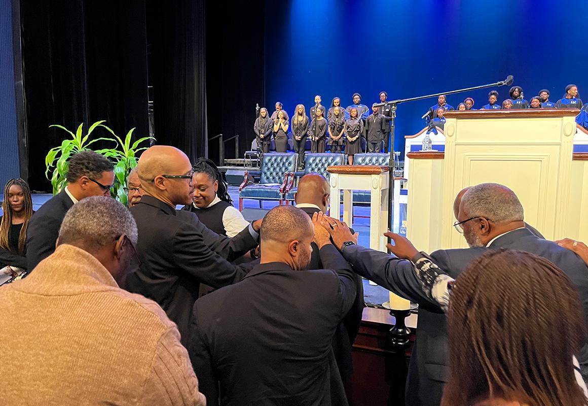 Sen. Raphael Warnock accepts prayers from elders at Howard's Rankin Chapel Service 