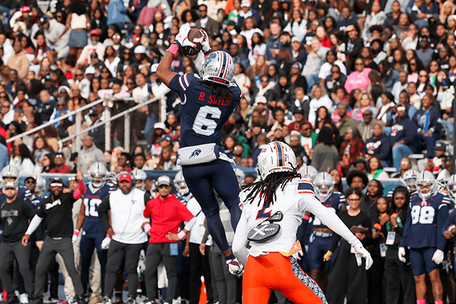 Howard football player jumping in the air for a catch during homecoming game