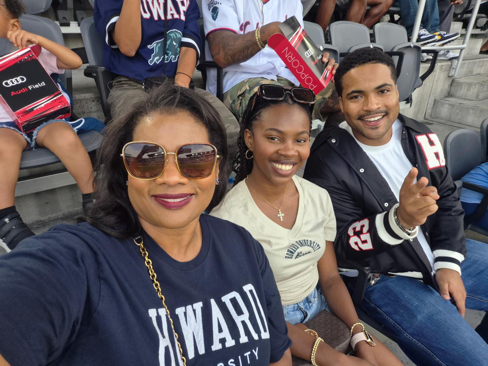 Jaden Madgett and family sitting in bleacher stands