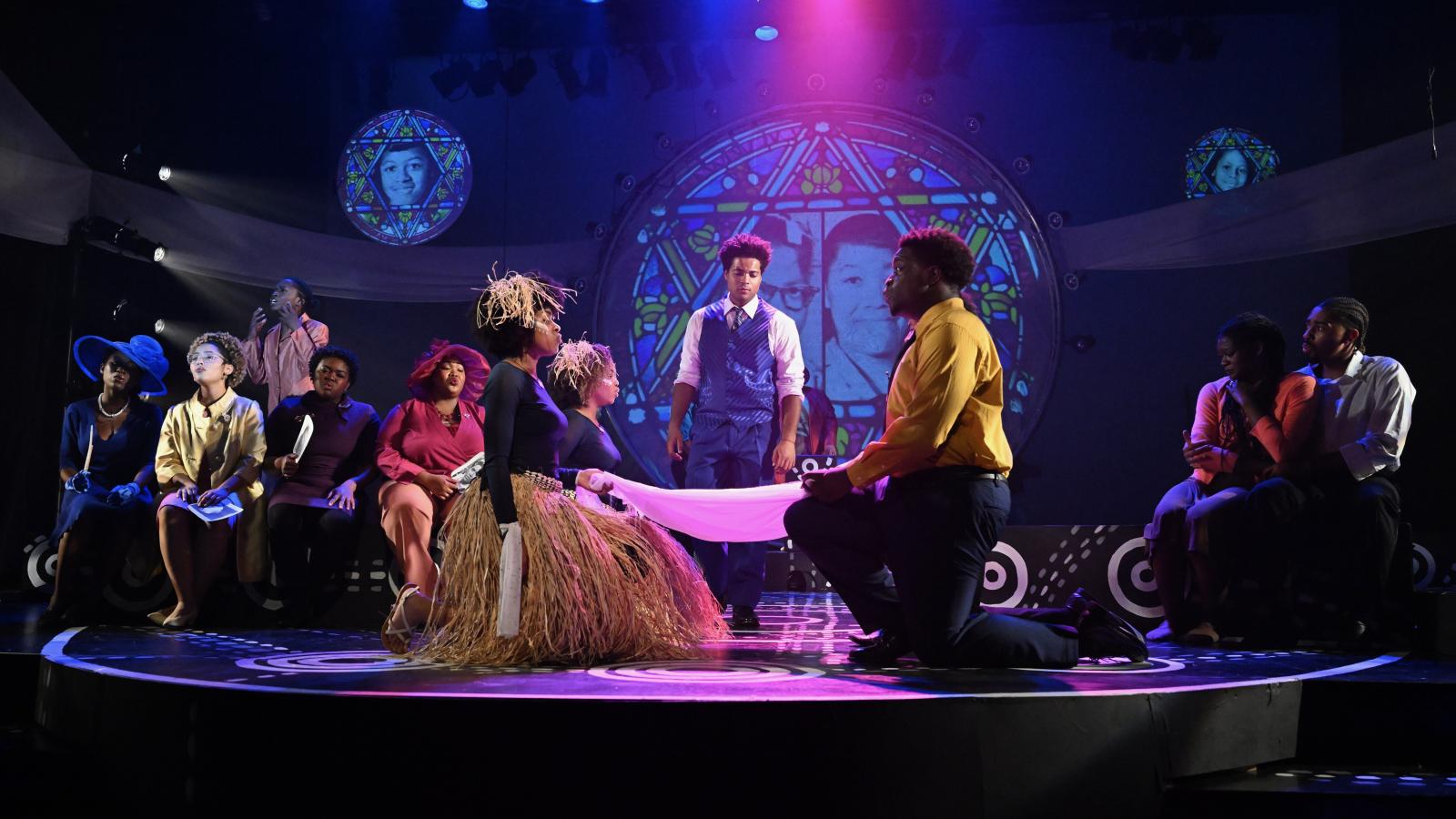 Jaden Madgett on stage (center) with several other actors