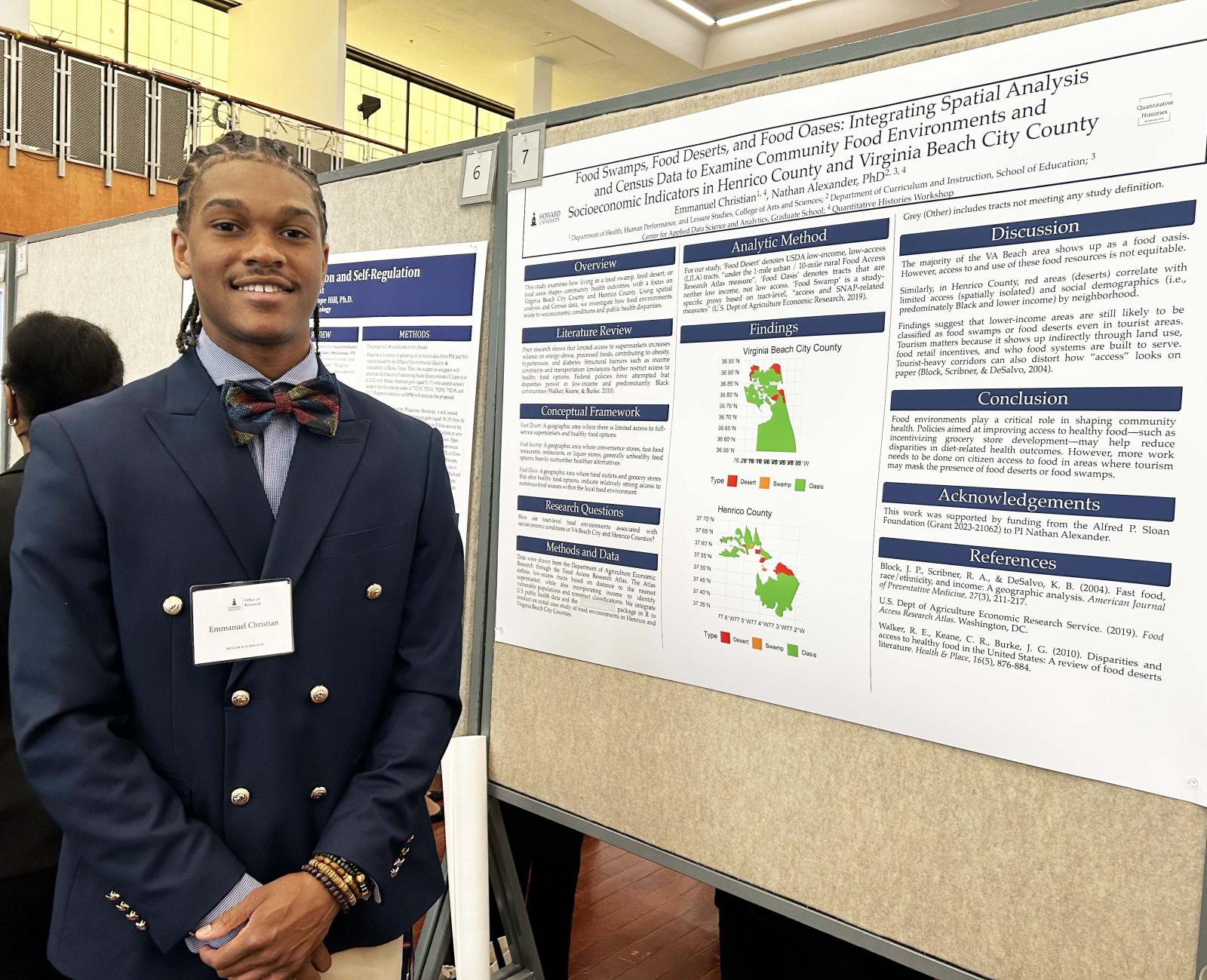 Emmanuel Christian standing in front of a poster board with research findings written on the paper
