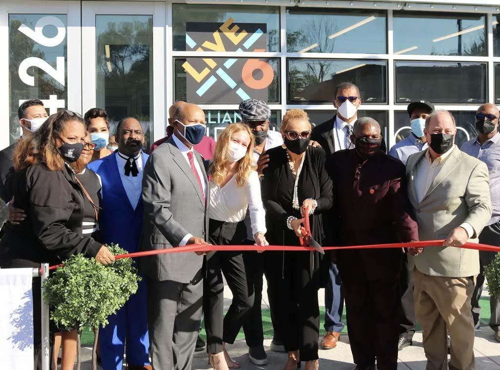 Live6 opening ceremony ribbon cutting. There are several people wearing masks