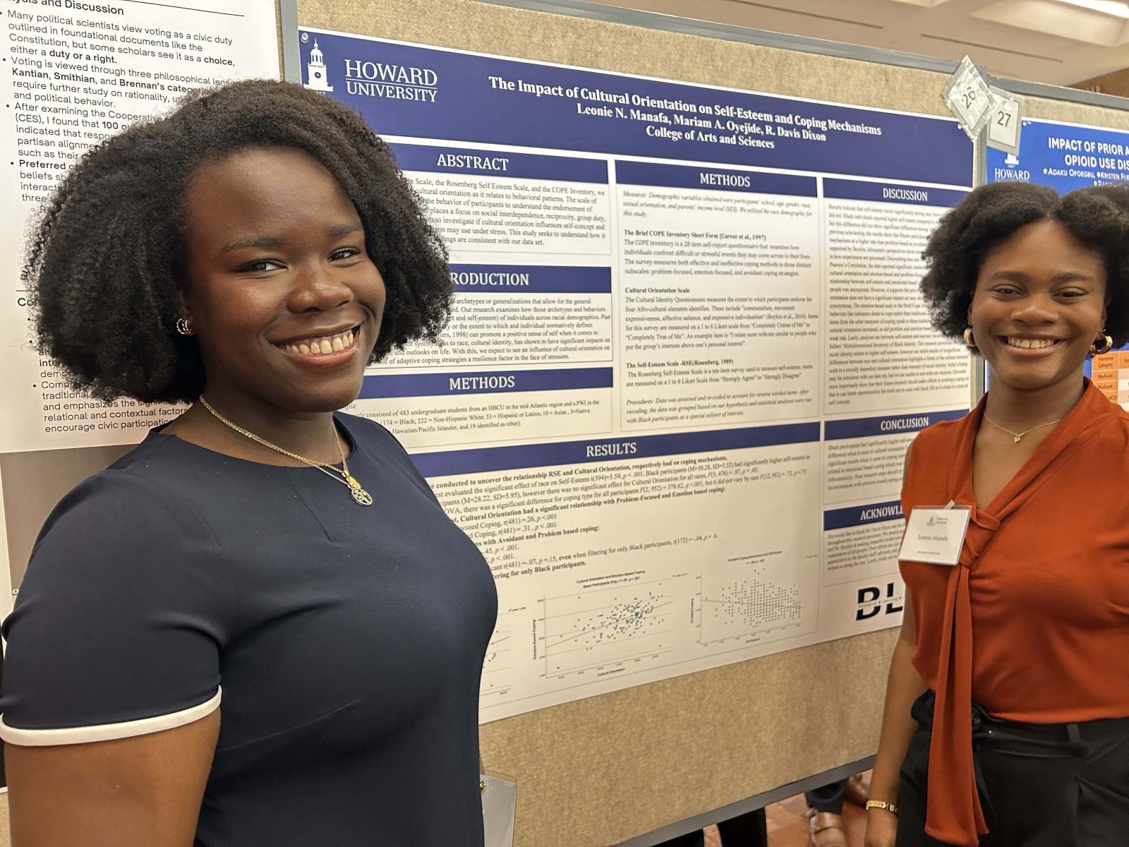 Two female college students standing in front of a poster board with research findings