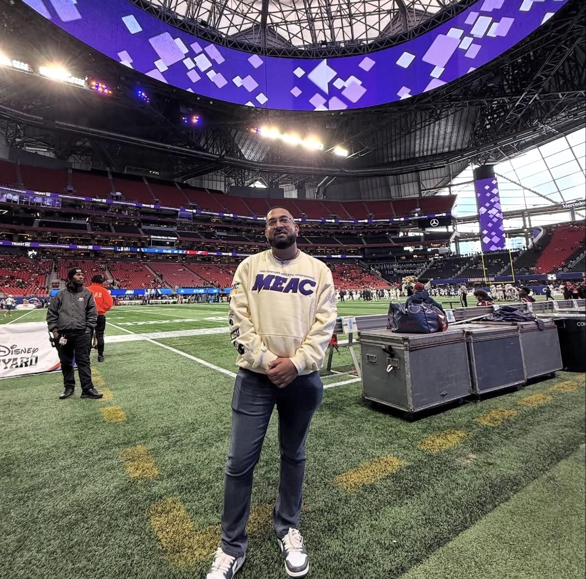 Bilal Badruddin standing on a football field