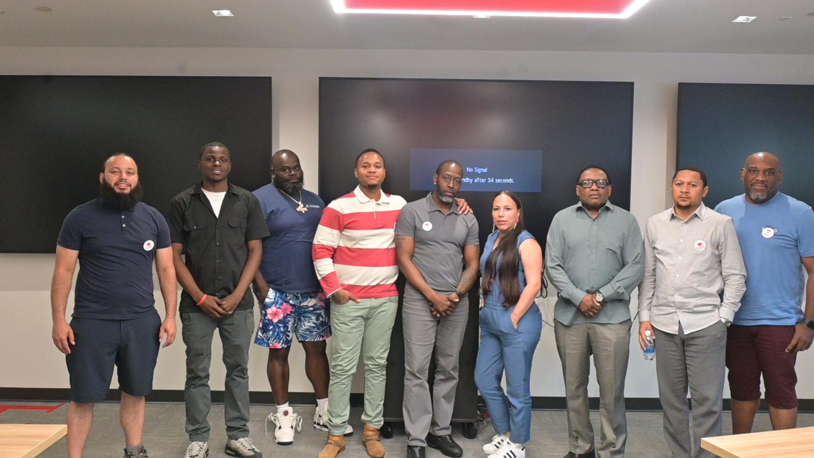 A group of 10 people standing next to each other