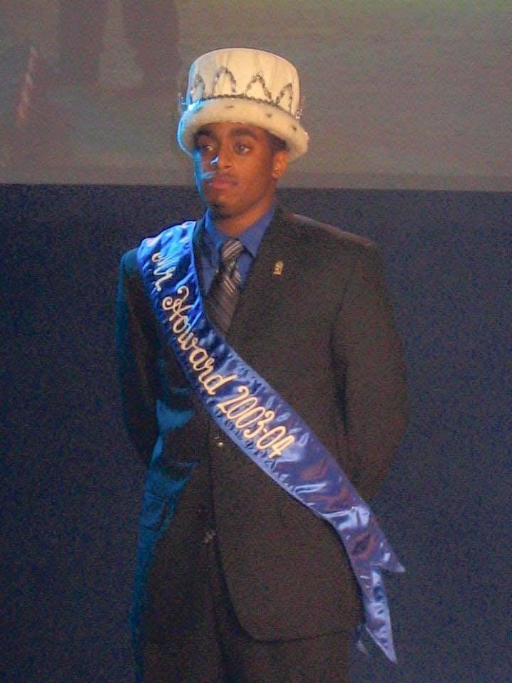 Chequan Lewis wearing a crown on his head and a sash around his body that says Mister Howard