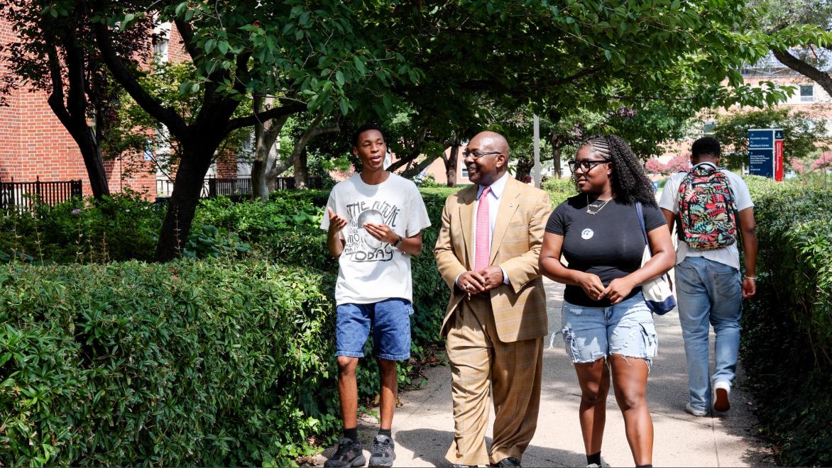 Provost Anthony Wutoh walked around campus while talking to two students