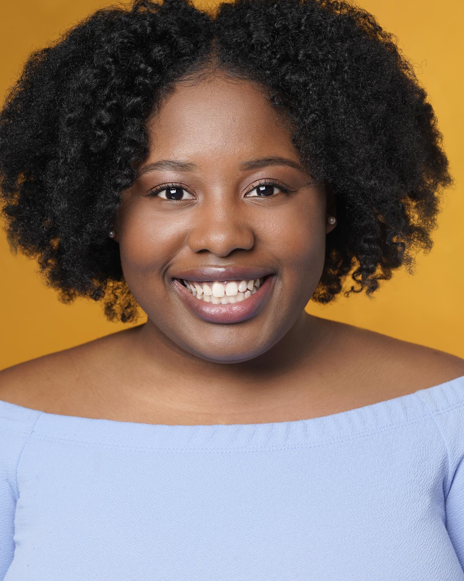 Howard alum Kalen Robinson smiling in a headshot. She's wearing a baby blue top