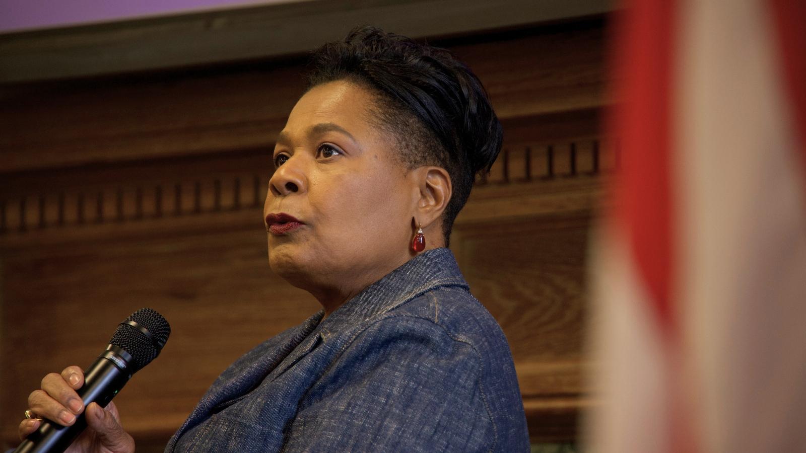 Paula-Mae Weekes, Trinidad's first woman president, sitting and holding a microphone