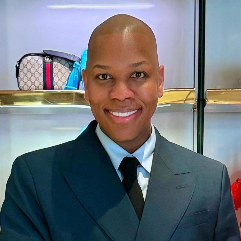 Models Inc. Aaron Handy wearing a dark suit and smiling