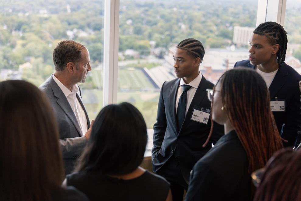 Marriott CEO Anthony Capuano talking with Howard students during students' visit to Marriott