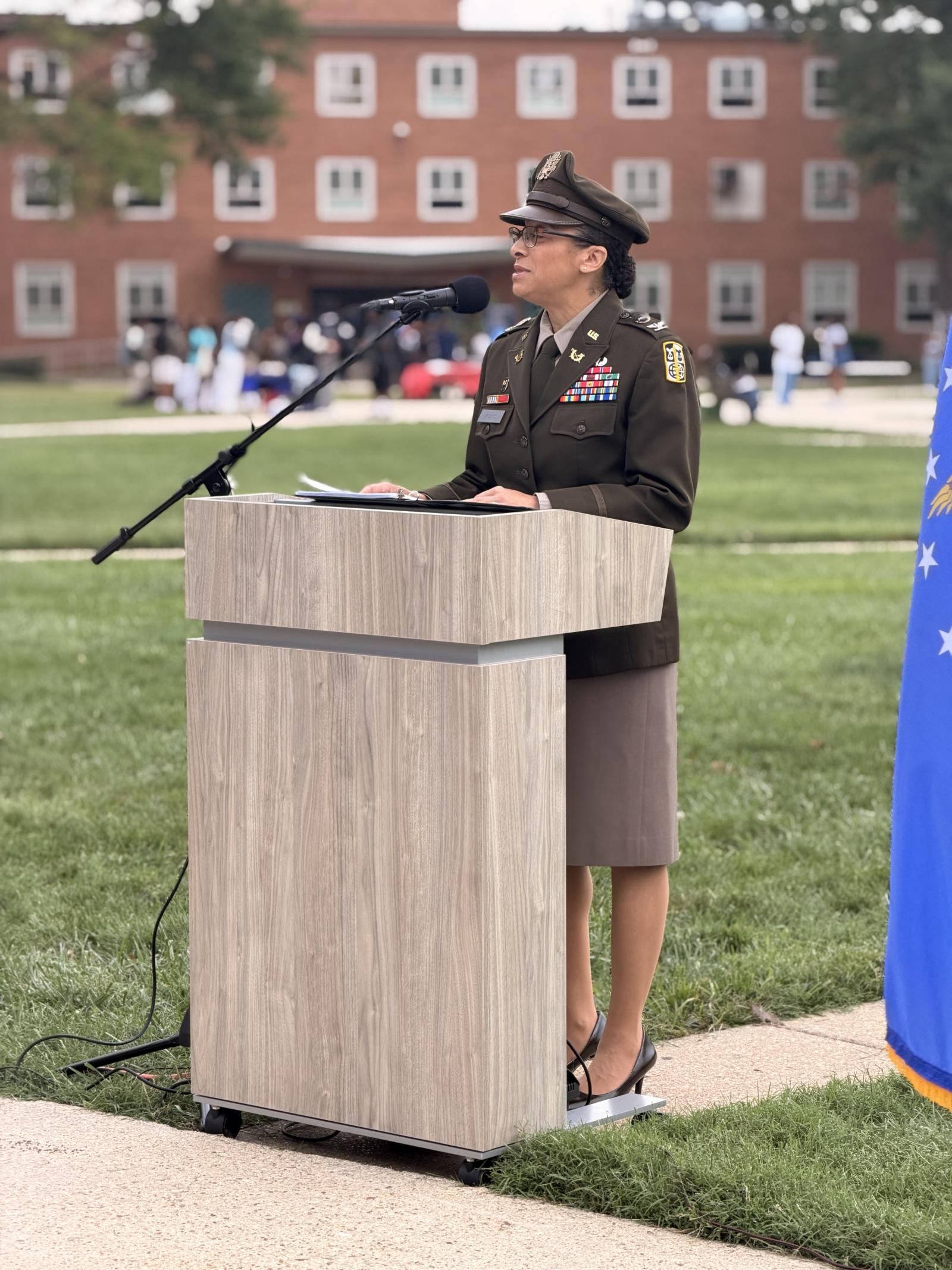 Col. LaJohnne A.W. Morris wearing military uniform standing at a podium in The Yard