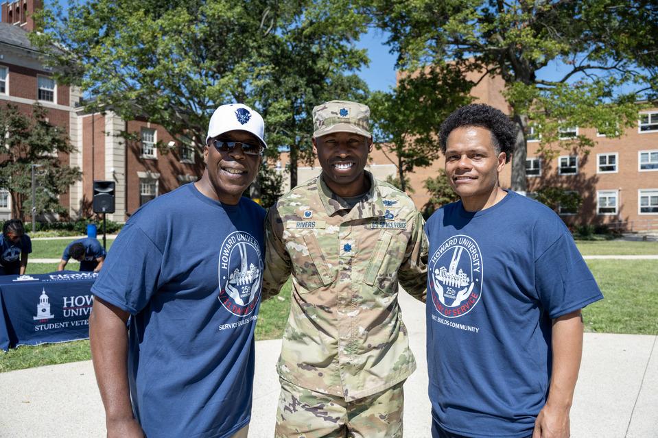 Sgt. Michael Mack (left), an ROTC cadet in camo, and Dr. Paris Adon standing in The Yard side by side