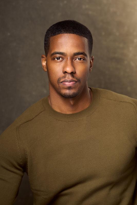 Actor and Howard adjunct instructor Derrick King wearing a brown sweater