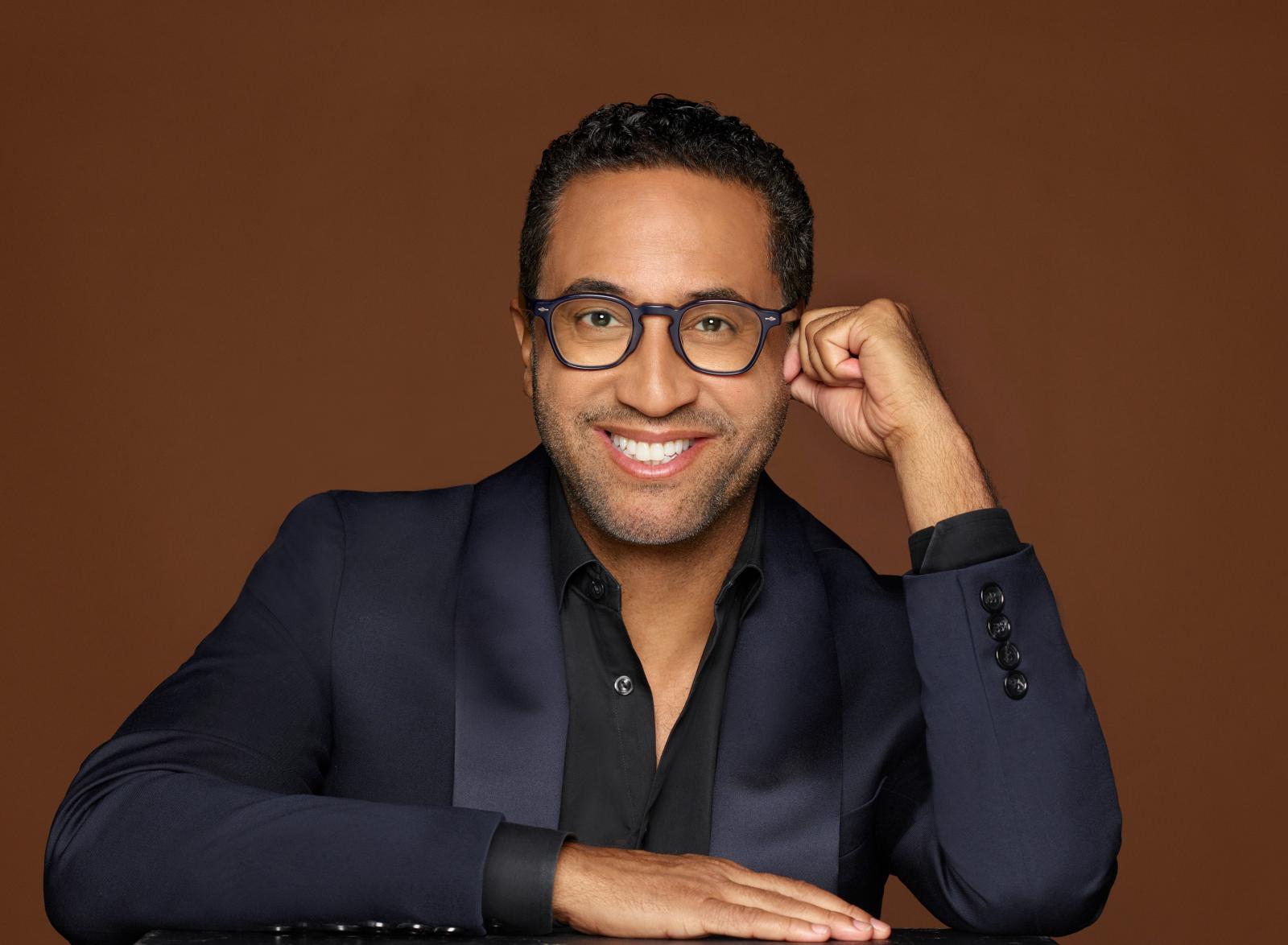 Headshot of C. Brian Williams wearing a blue blazer and black shirt