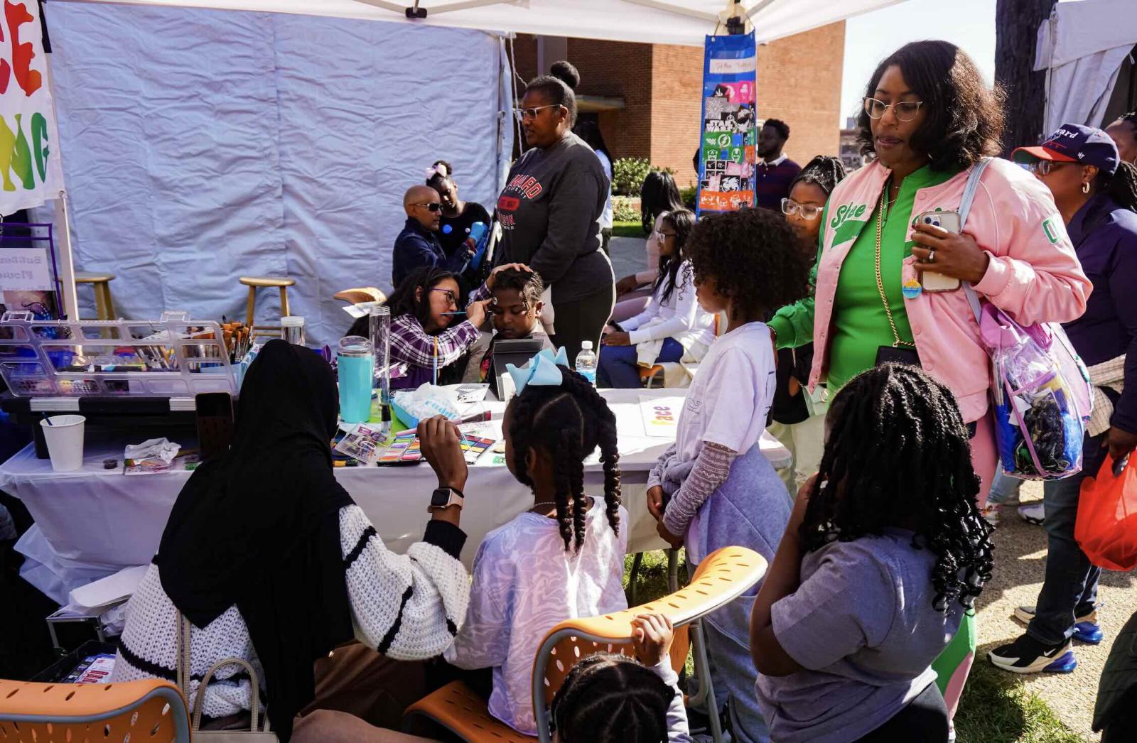 Children doing fun activities at FamFest 2025 while an adult looks on