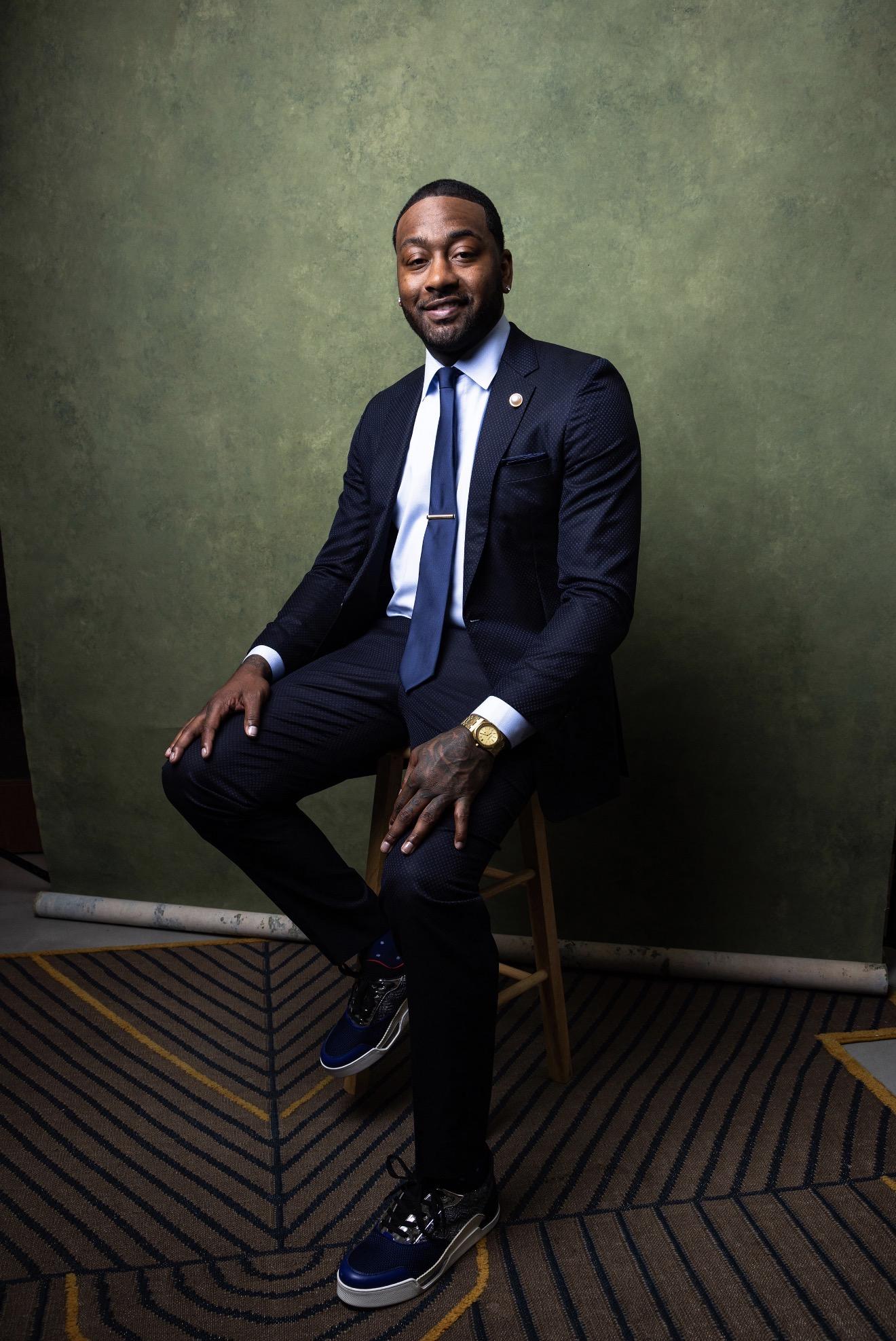 Howard Basketball's John Wall wearing a dark suit seated