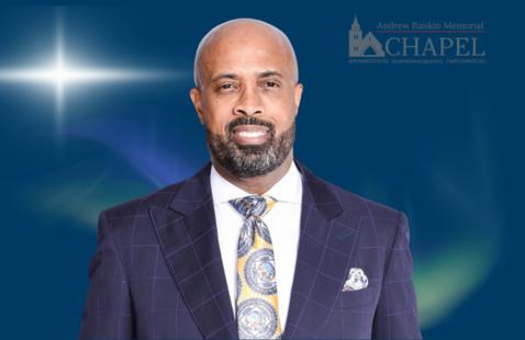  Rev. Frederick D. Haynes III, Ph.D smiling wearing a dark suit