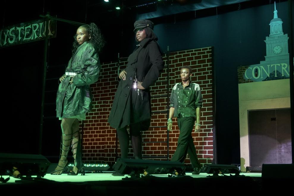 Models at Howard University Student Fashion Show at Homecoming 2025 shrouded in green lighting on the runway