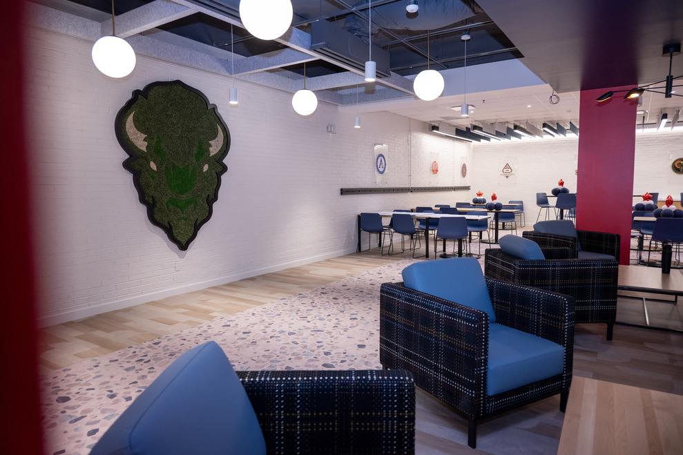 Blue cozy chairs and a large Bison head on the wall at the new PunchOut