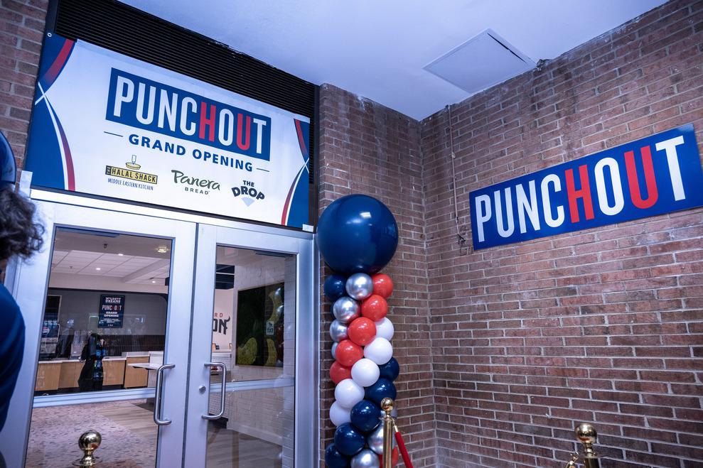 The entrance to the new PunchOut includes red brick wall and two glass doors with a sign over the doors