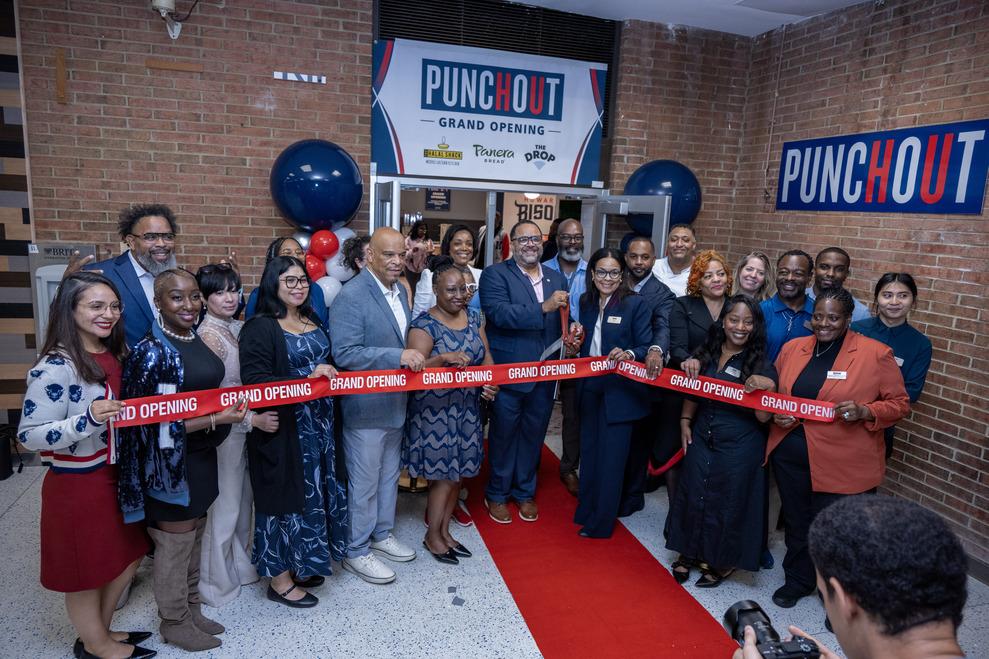 University leaders line up side by side at the ribbon-cutting for the PunchOut