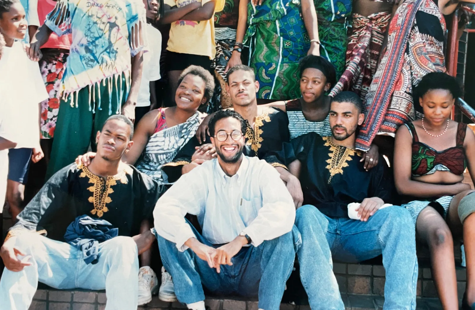 C. Brian Williams in South Africa surrounded by dancers at the founding at Step Afrika! in 1994